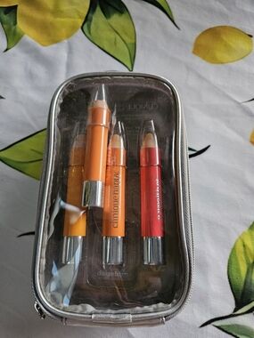 Clinique Happy, Hint Of Citrus, And Flowers Crayon Set in Orange and Red